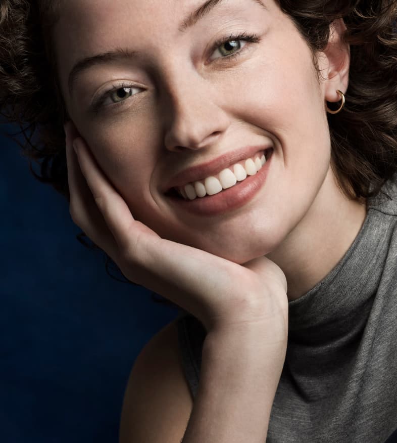 Smiling young adult female patient after treatment