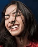 Smiling and laughing young adult female patient after treatment